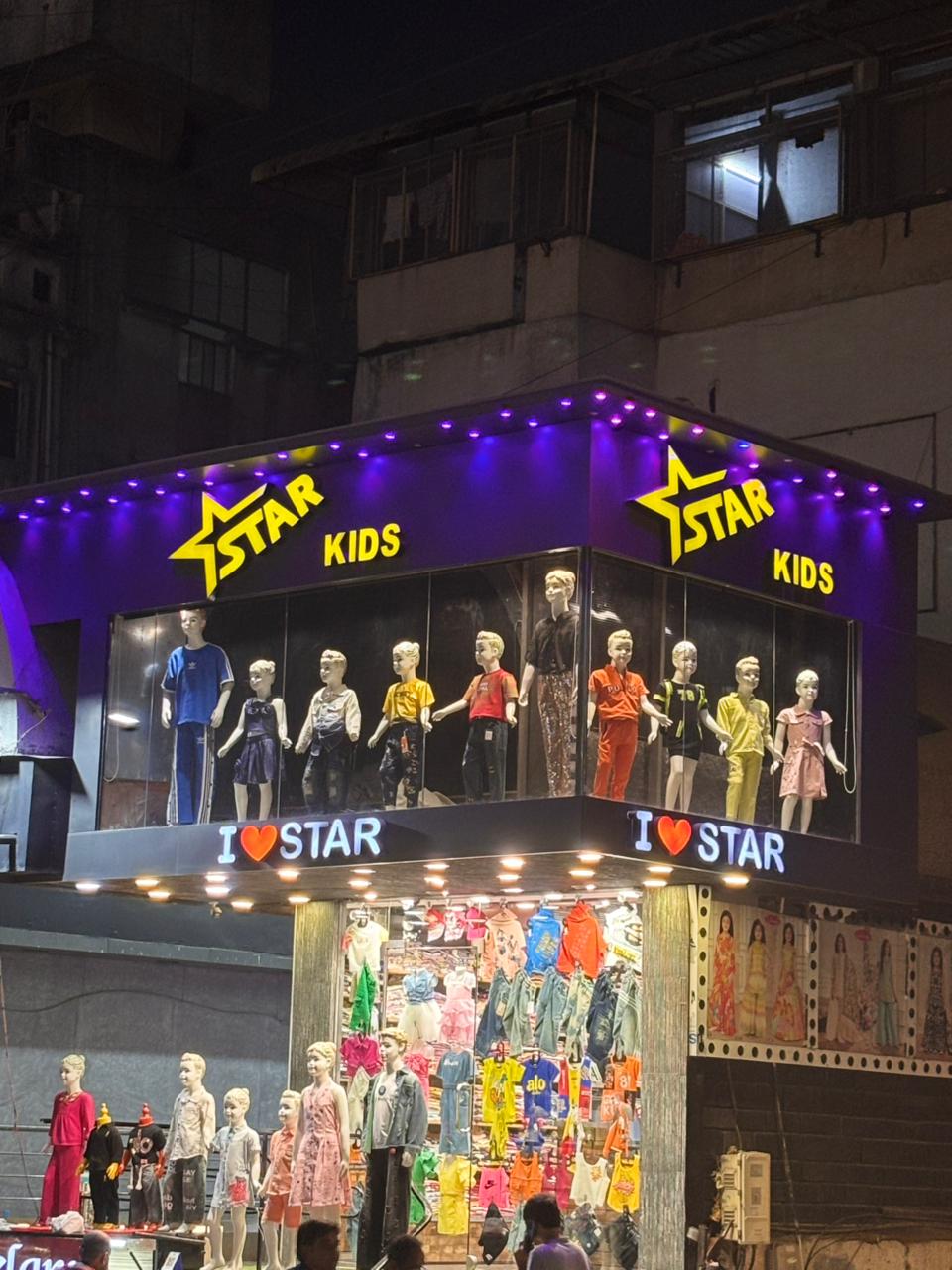 Star Kids storefront lit up at night